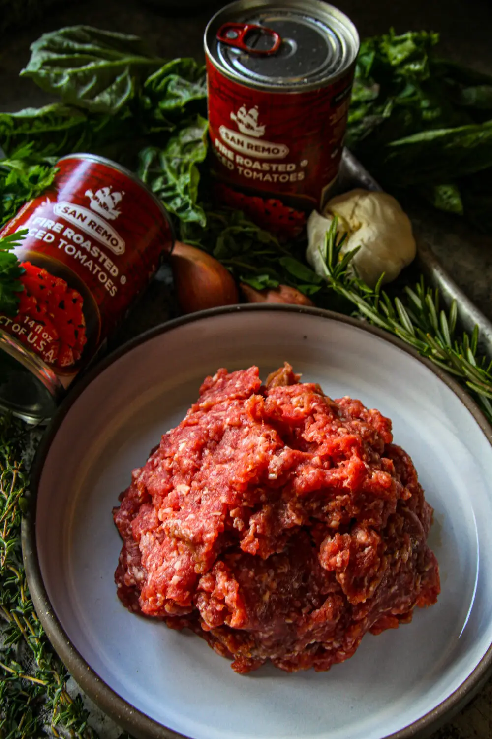 ground lamb, canned tomatoes and herbs
