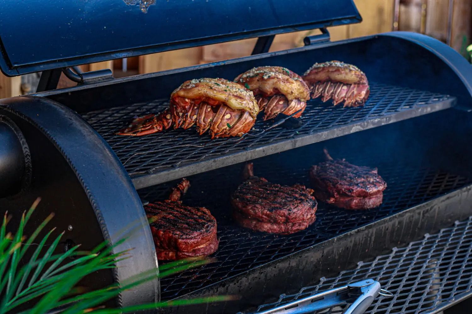 lobster tails and tomahawks on grill