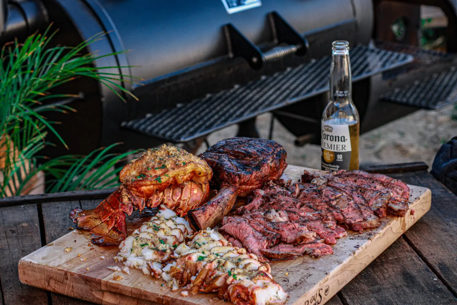 reverse seared tomahawk ribeyes and smoked lobster tails