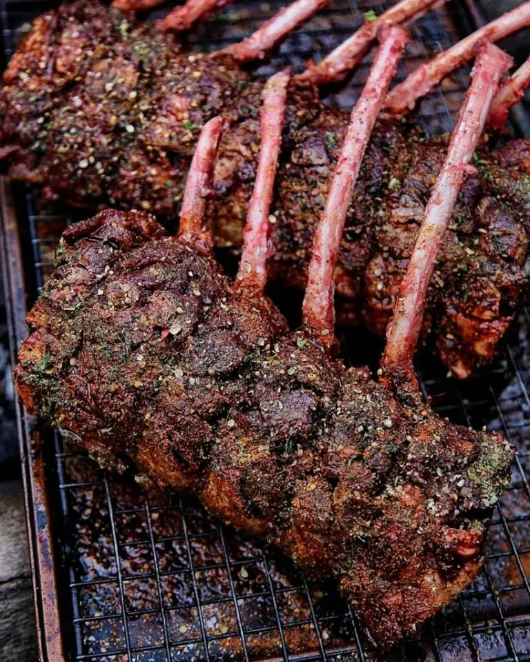 Deliciously seasoned rack of lamb on a cooling rack, cooked to perfection for a savory gourmet meal.