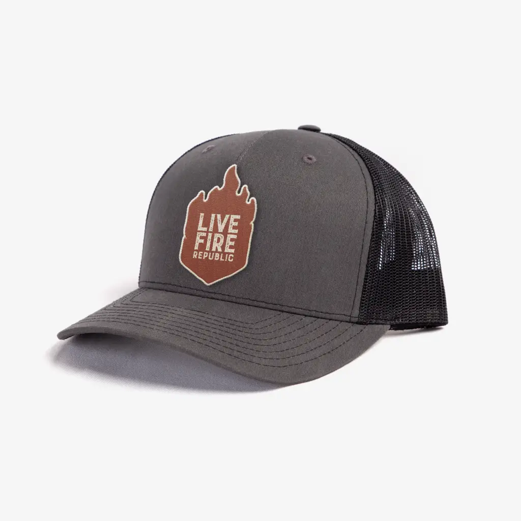 Dark gray trucker hat with Live Fire Republic logo on the front, featuring mesh back and curved brim.