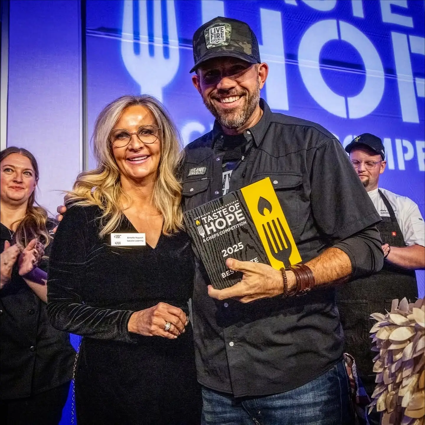 Smiling winner holds Taste of Hope 2025 award.