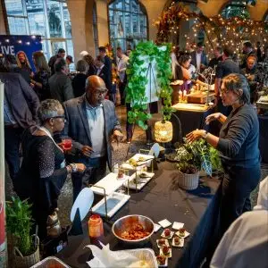 Guests sample appetizers at a decorated indoor event.