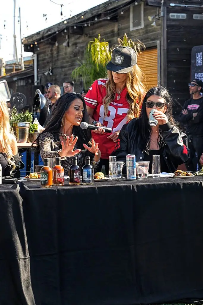 Women judge food at an outdoor food event