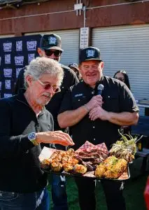 Men enjoying barbecue at an outdoor live-fire food event
